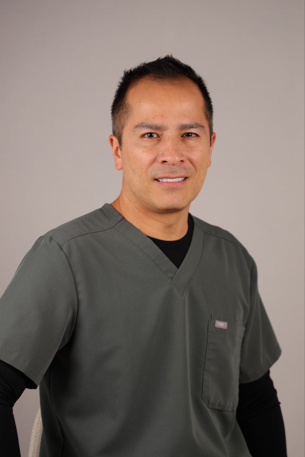 Dr. Castillo in medical scrubs